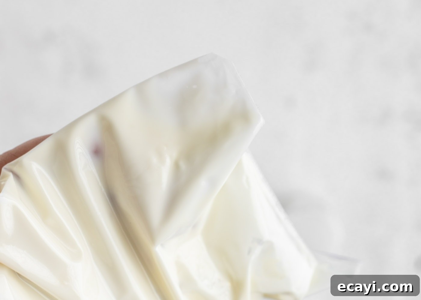 Crystalline Dream Cake 10 Melted white chocolate on a spatula, perfectly smooth and ready for piping.
