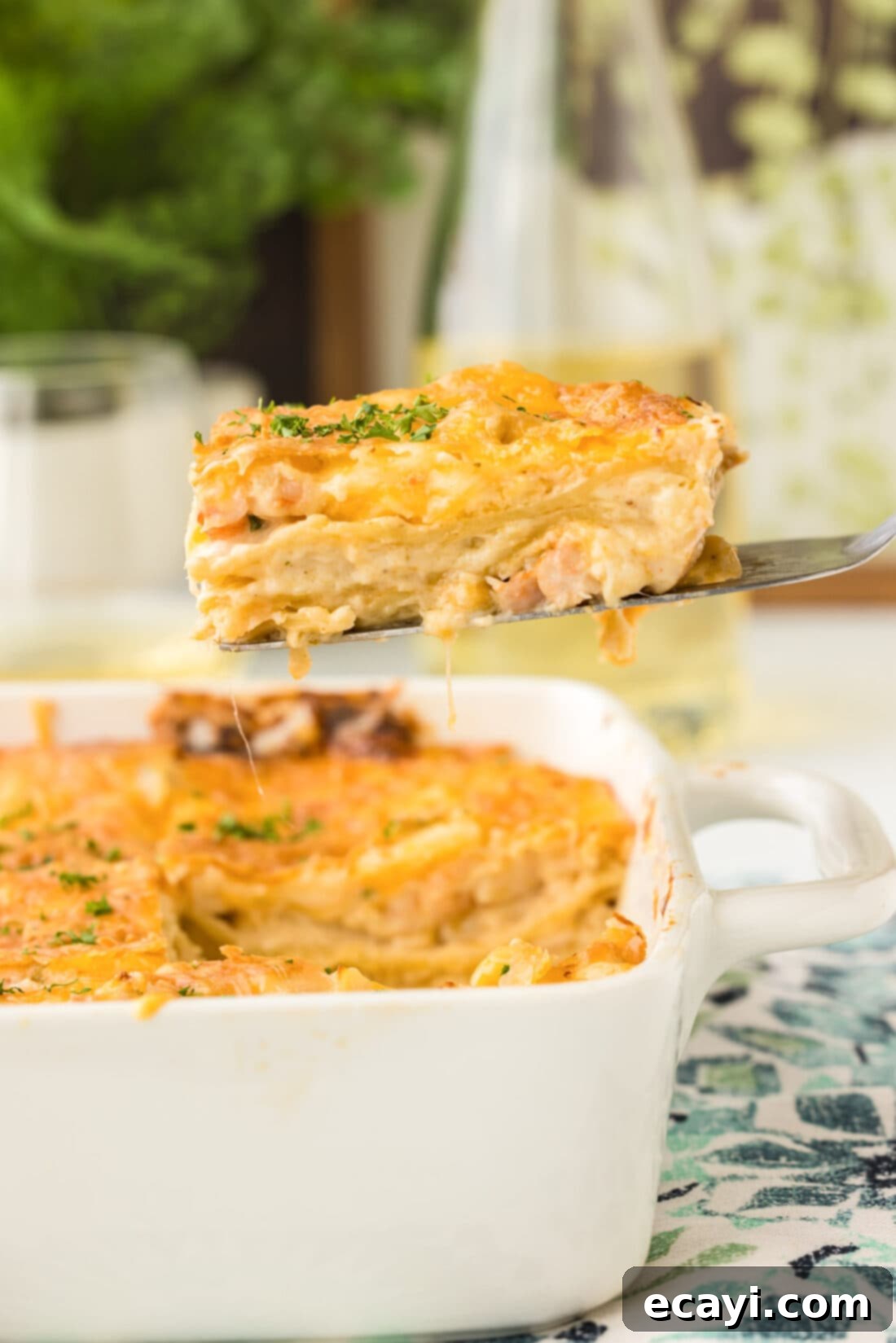 Ocean's Bounty Lasagna 2 A perfectly portioned slice of creamy seafood lasagna being lifted from the pan, showcasing its rich layers of seafood, noodles, and cheese.