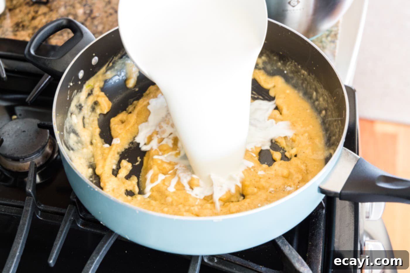 Ocean's Bounty Lasagna 13 Pouring half and half into the skillet with the roux.