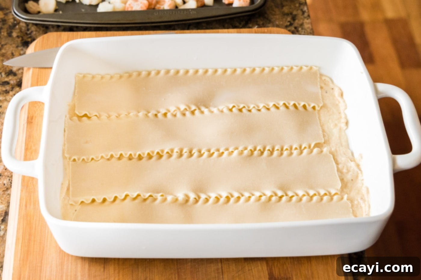 Ocean's Bounty Lasagna 16 Placing soaked lasagna noodles over the cream sauce in the baking dish.