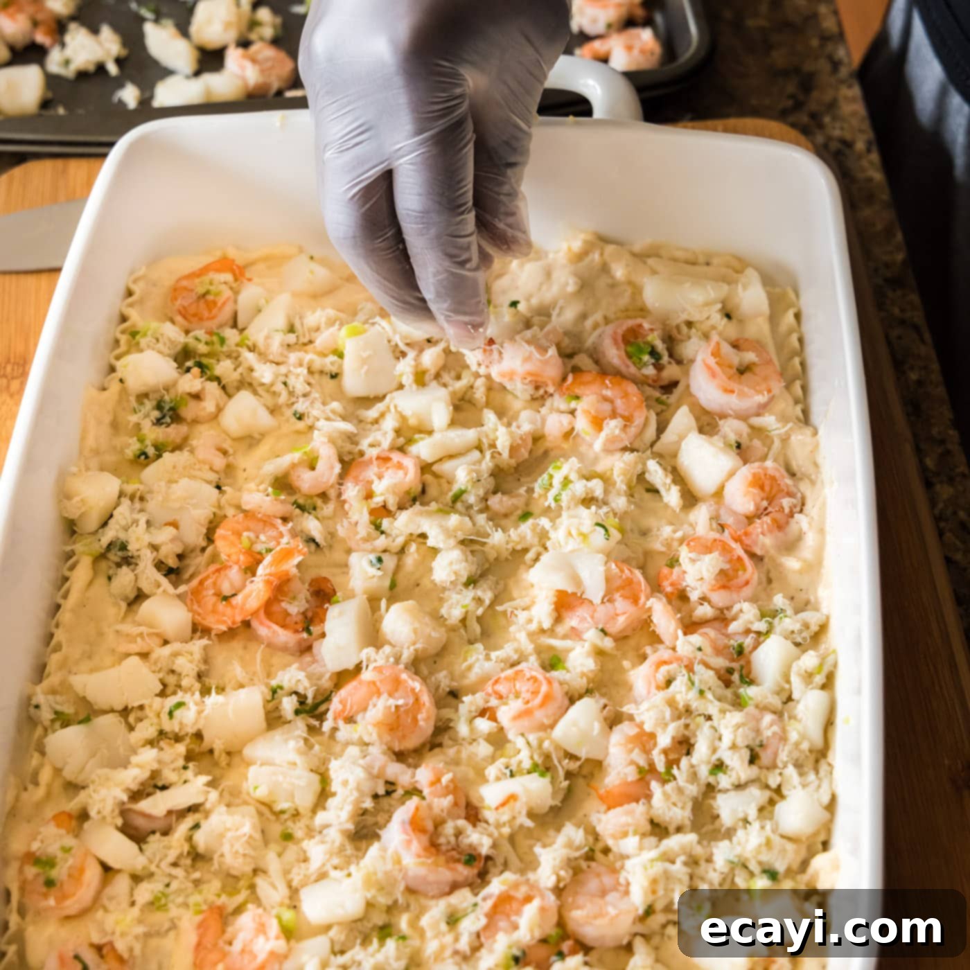 Ocean's Bounty Lasagna 18 Adding a layer of cooked seafood (crab, scallops, and shrimp) on top of the cream sauce layer.