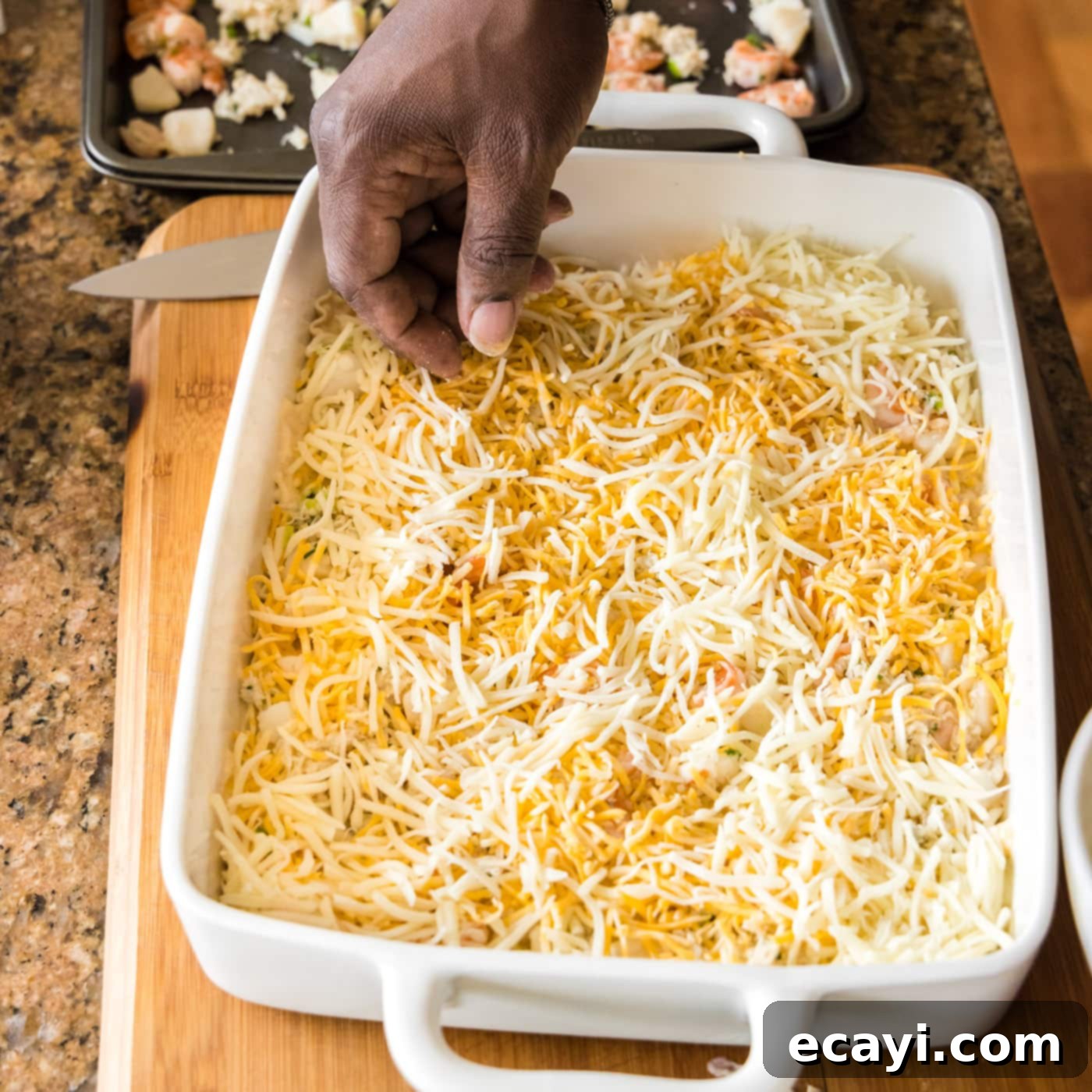 Ocean's Bounty Lasagna 19 Sprinkling shredded Colby Jack and mozzarella cheese over the seafood layer.
