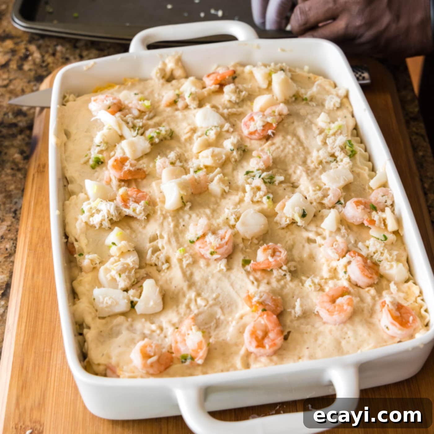 Ocean's Bounty Lasagna 21 Assembled seafood lasagna in a baking dish before the final cheese layer.