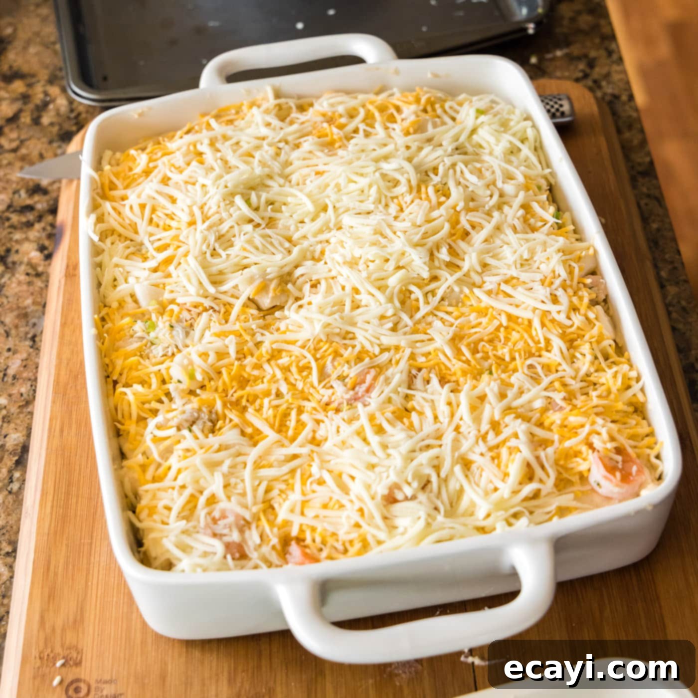 Ocean's Bounty Lasagna 22 The top layer of seafood lasagna covered generously with shredded cheese, ready for baking.