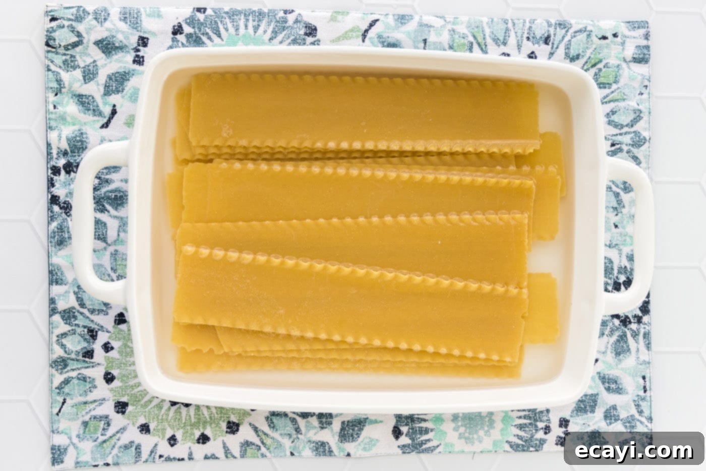 Ocean's Bounty Lasagna 5 Lasagna noodles soaking in a 13x9 baking dish filled with hot water.