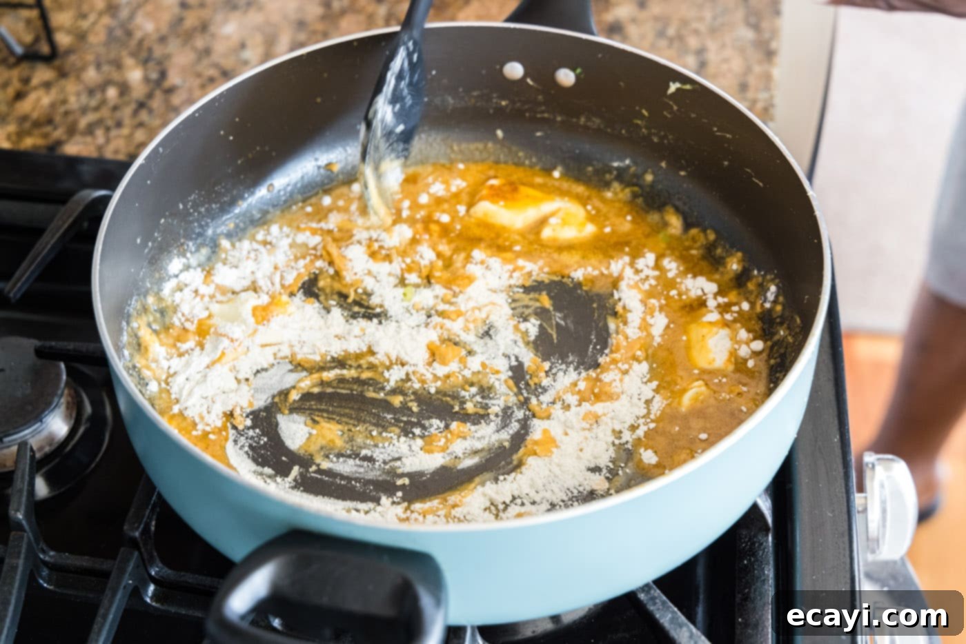 Ocean's Bounty Lasagna 10 Mixing flour into melted butter and seasonings in a skillet to create a roux.
