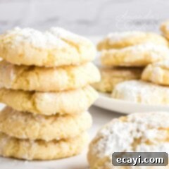 Sun-Kissed Orange Crinkles 4 A delightful stack of soft and chewy orange crinkle cookies, generously dusted with powdered sugar, ready to be enjoyed.