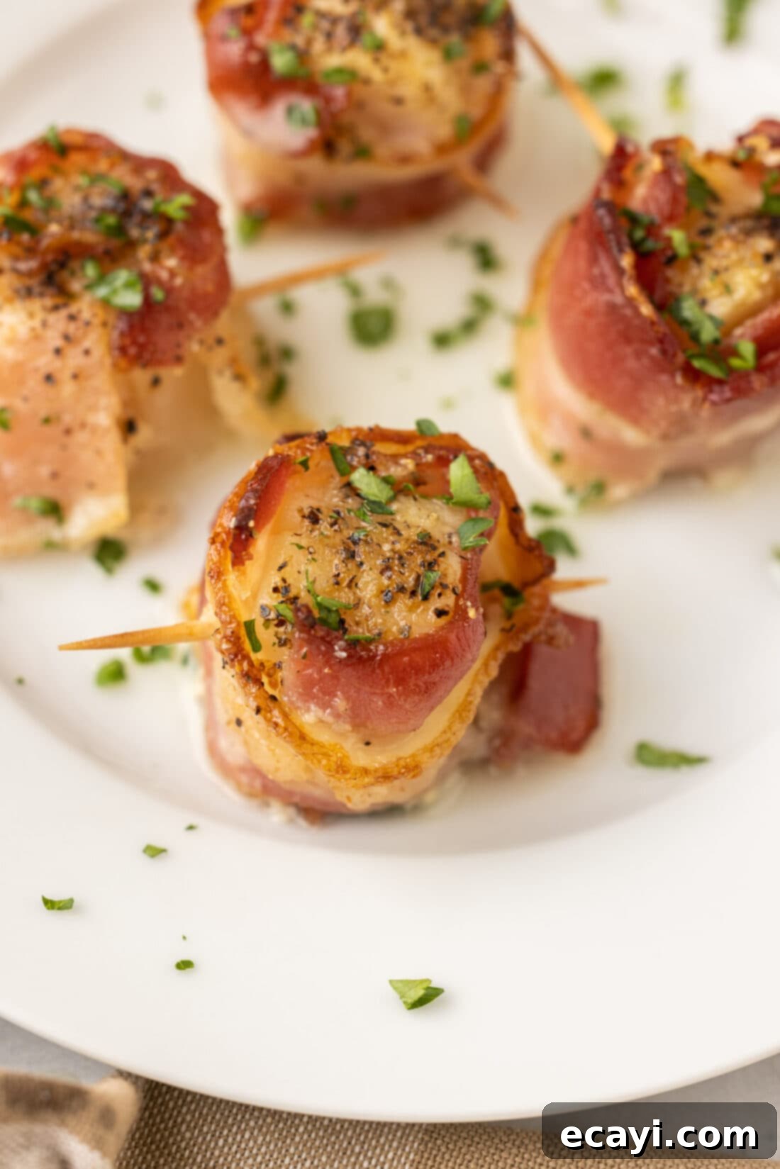 Sea Scallops Draped in Bacon 2 Bacon Wrapped Scallops on plate