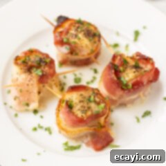 Sea Scallops Draped in Bacon 8 Bacon Wrapped Scallops on a white plate