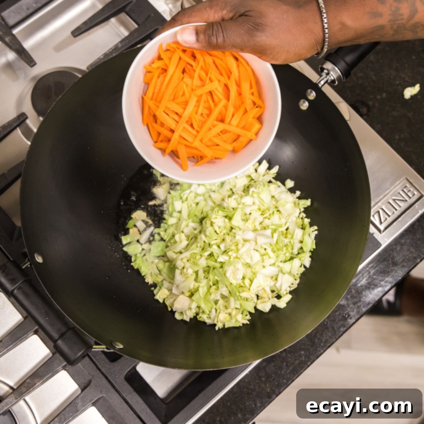 Chow Mein 6 adding carrots with cabbage to a wok