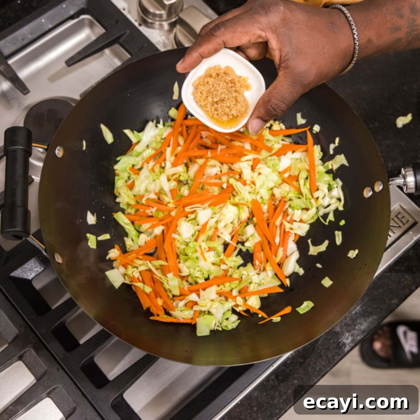 Chow Mein 7 adding garlic to wok with carrot and cabbage