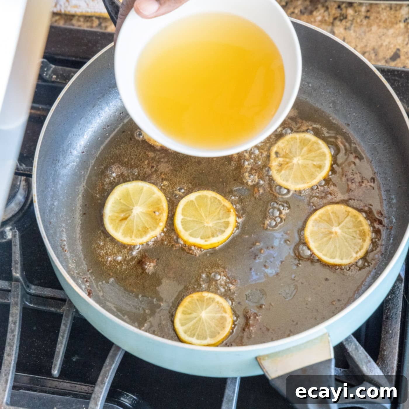 Golden Lemon Chicken 13 adding chicken stock to lemon and chicken pan juices