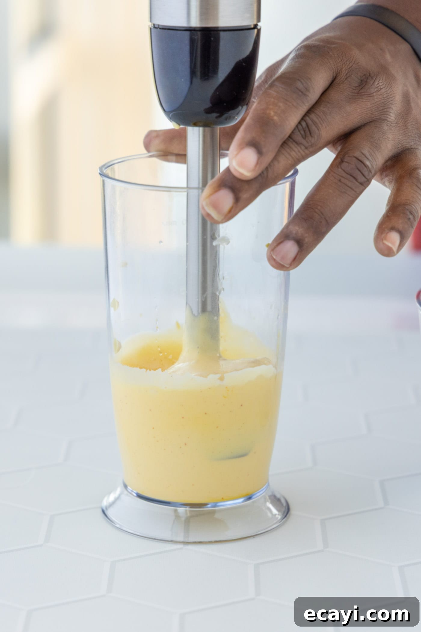 Classic Hollandaise Sauce 7 blending hollandaise sauce with an immersion blender