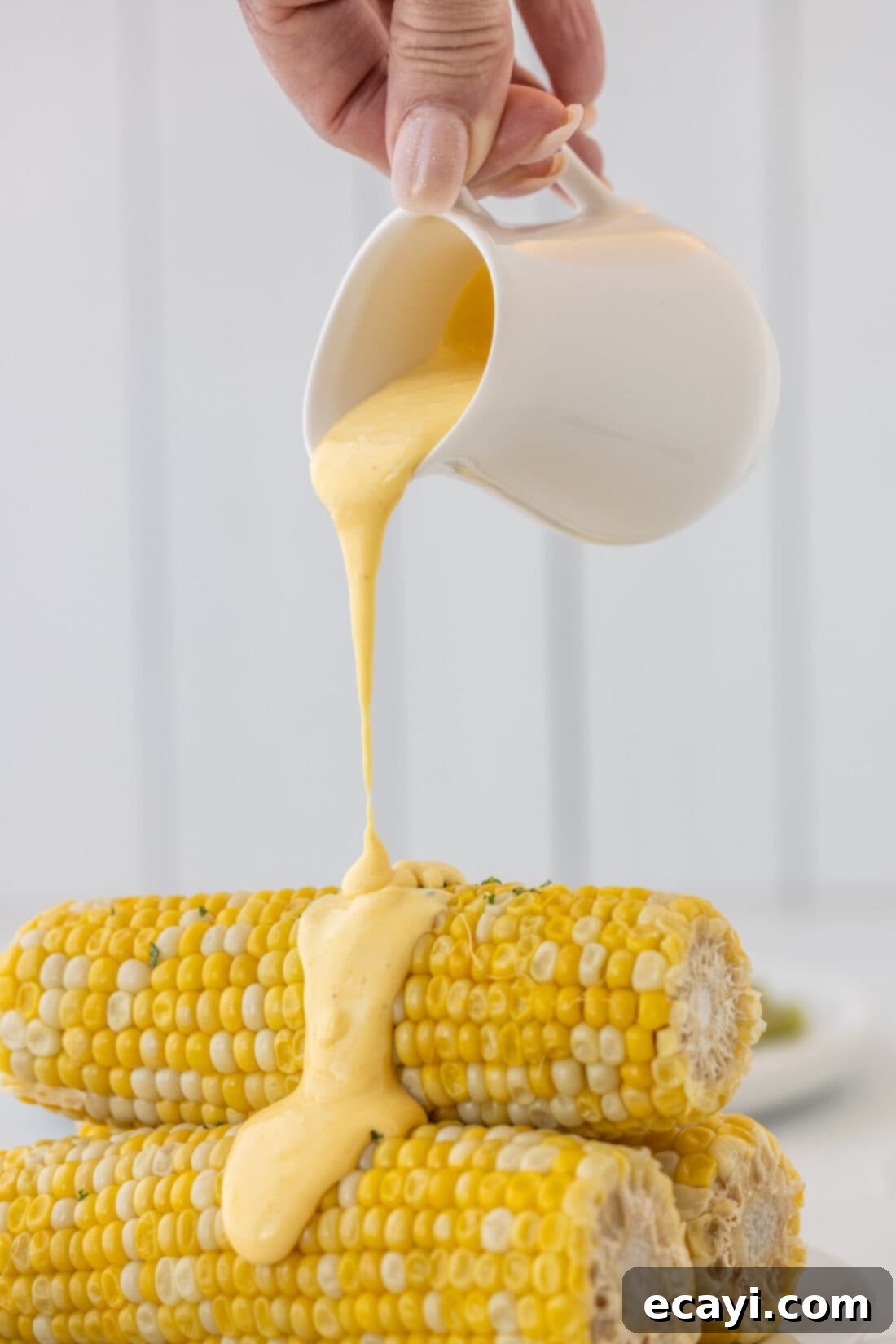 Classic Hollandaise Sauce 8 pouring Hollandaise Sauce on corn