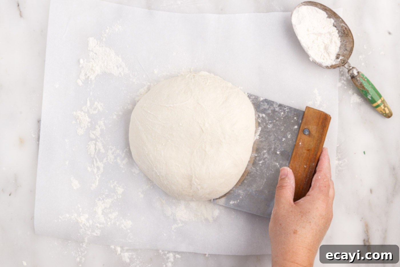 The Perfect Cast-Iron Loaf 12 scraping dough with bench scraper