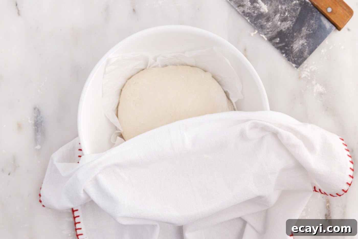 The Perfect Cast-Iron Loaf 13 covering dough in a bowl with a towel