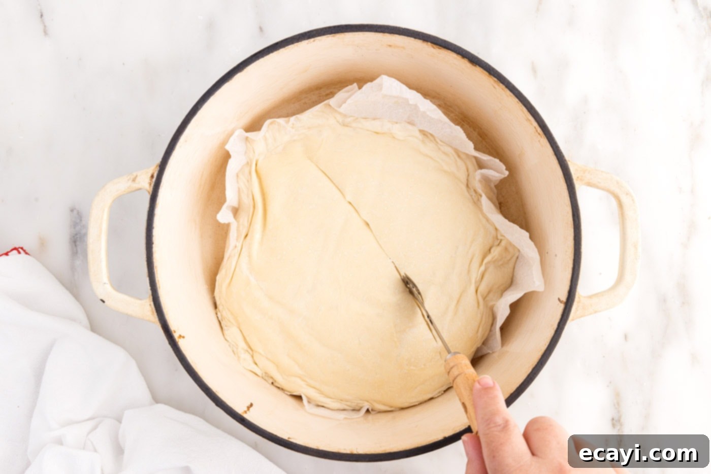 The Perfect Cast-Iron Loaf 15 scoring bread dough in a dutch oven