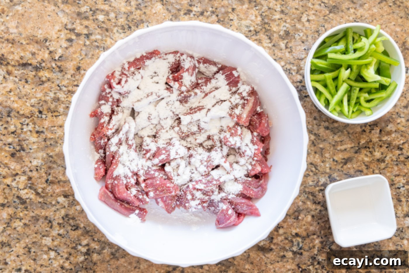 Fiery Szechuan Beef 5 Thinly sliced flank steak coated with cornstarch in a bowl