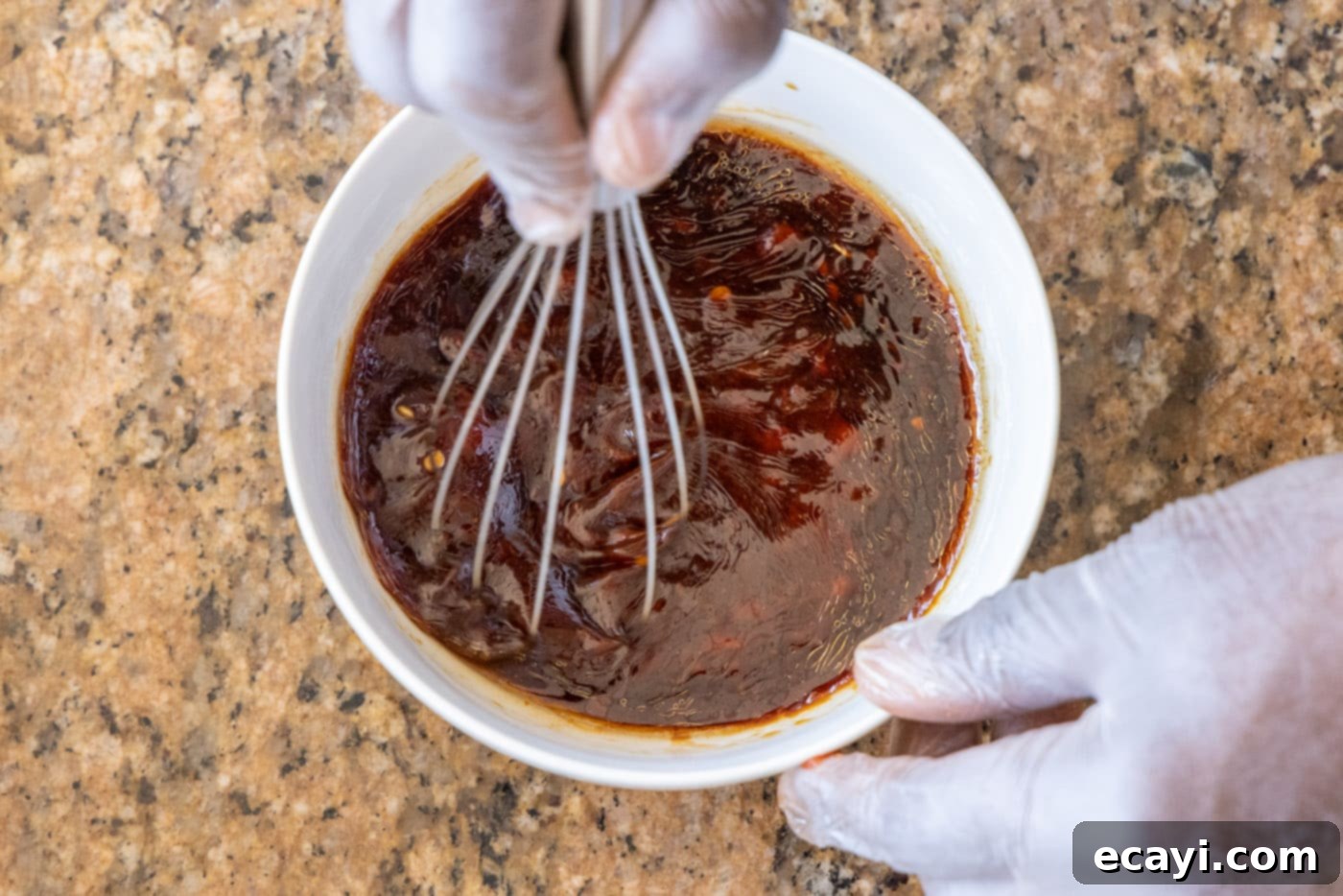 Fiery Szechuan Beef 7 A bowl of Kung Pao sauce being whisked to combine ingredients