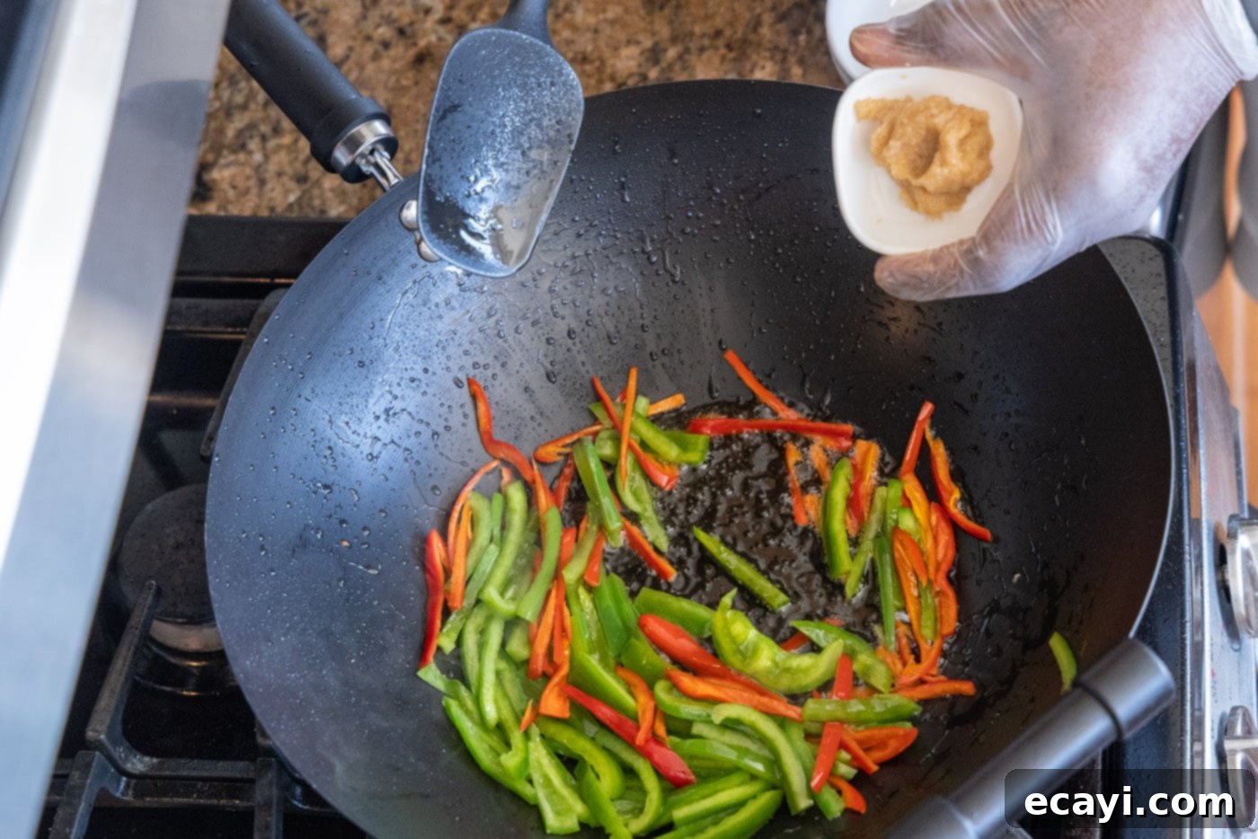 Fiery Szechuan Beef 10 Adding chopped ginger to the stir-frying vegetables