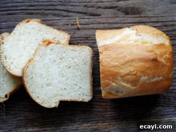 Amish White Bread Mini Loaves - AmandasCookin.com An overhead photo of a sliced Amish white bread mini loaf.