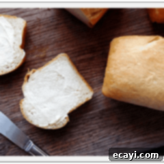 Homemade Amish White Mini Loaves 2 A close up photo of two buttered slices of Amish white bread.