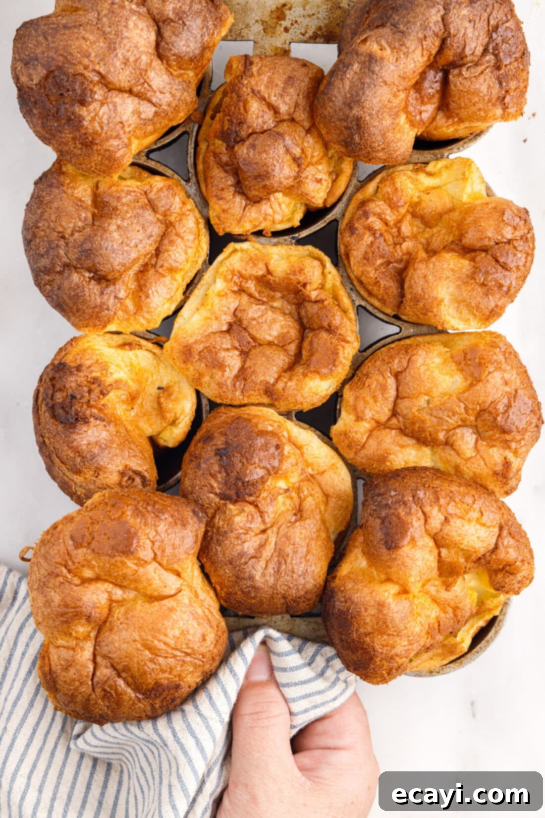 Light and Airy Popovers 3 Lifting a pan of freshly baked popovers from the oven