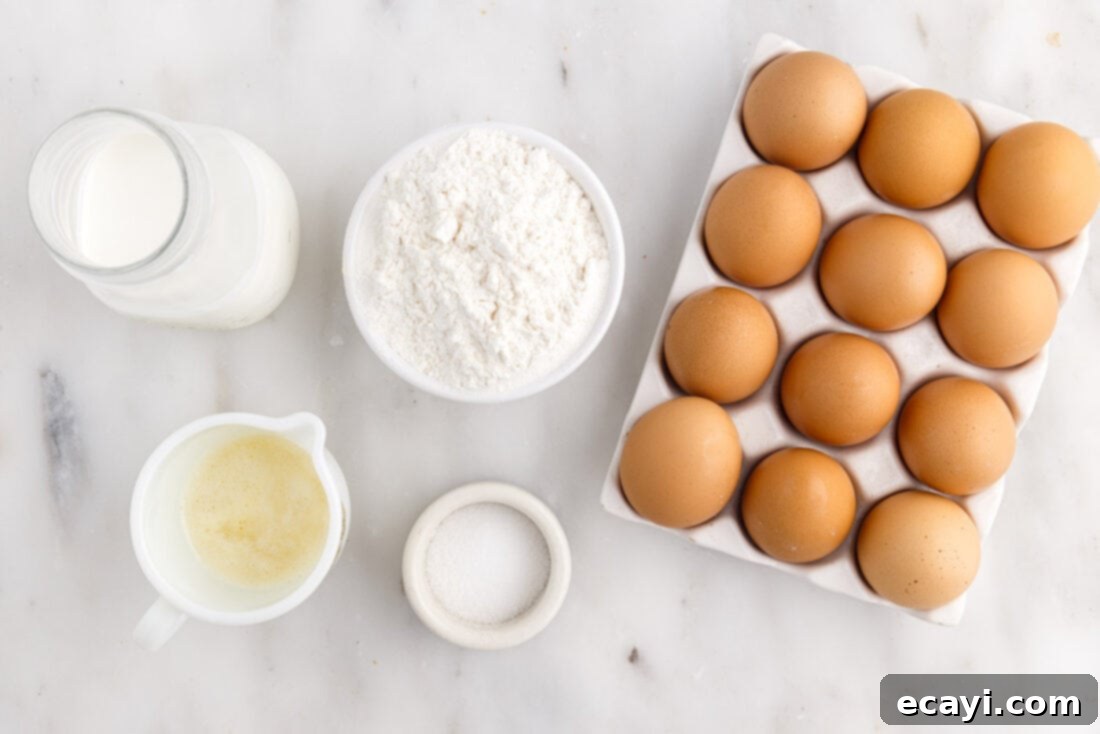 Light and Airy Popovers 4 Ingredients laid out for making popovers: flour, eggs, milk, butter, salt