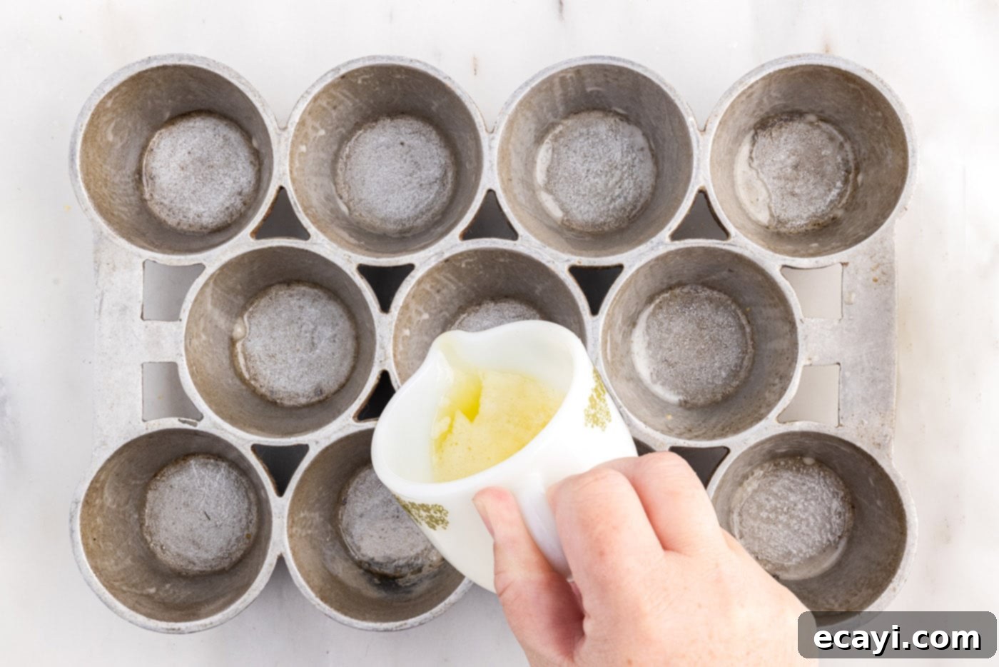 Light and Airy Popovers 8 Pouring melted butter into a warm popover pan