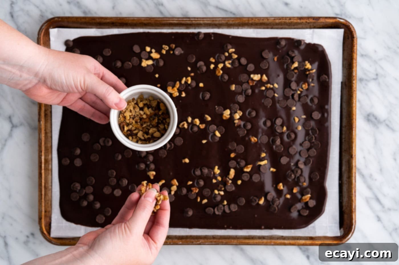 Brownie Bark 16 adding chopped nuts on top of brownie brittle