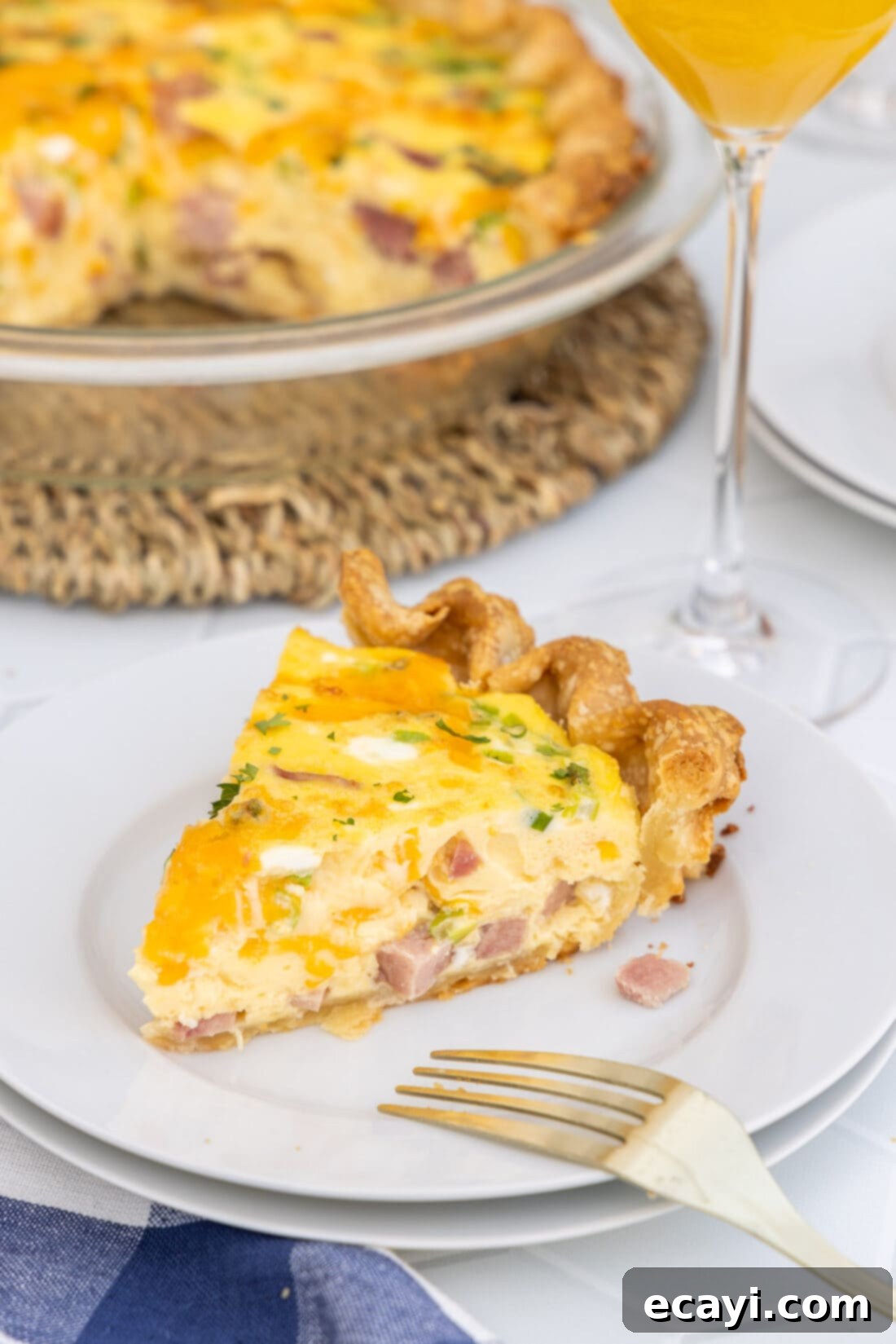 Savory Egg Custard Pie 2 A perfectly baked slice of Ham and Cheese Quiche with a golden-brown crust and visible fillings.