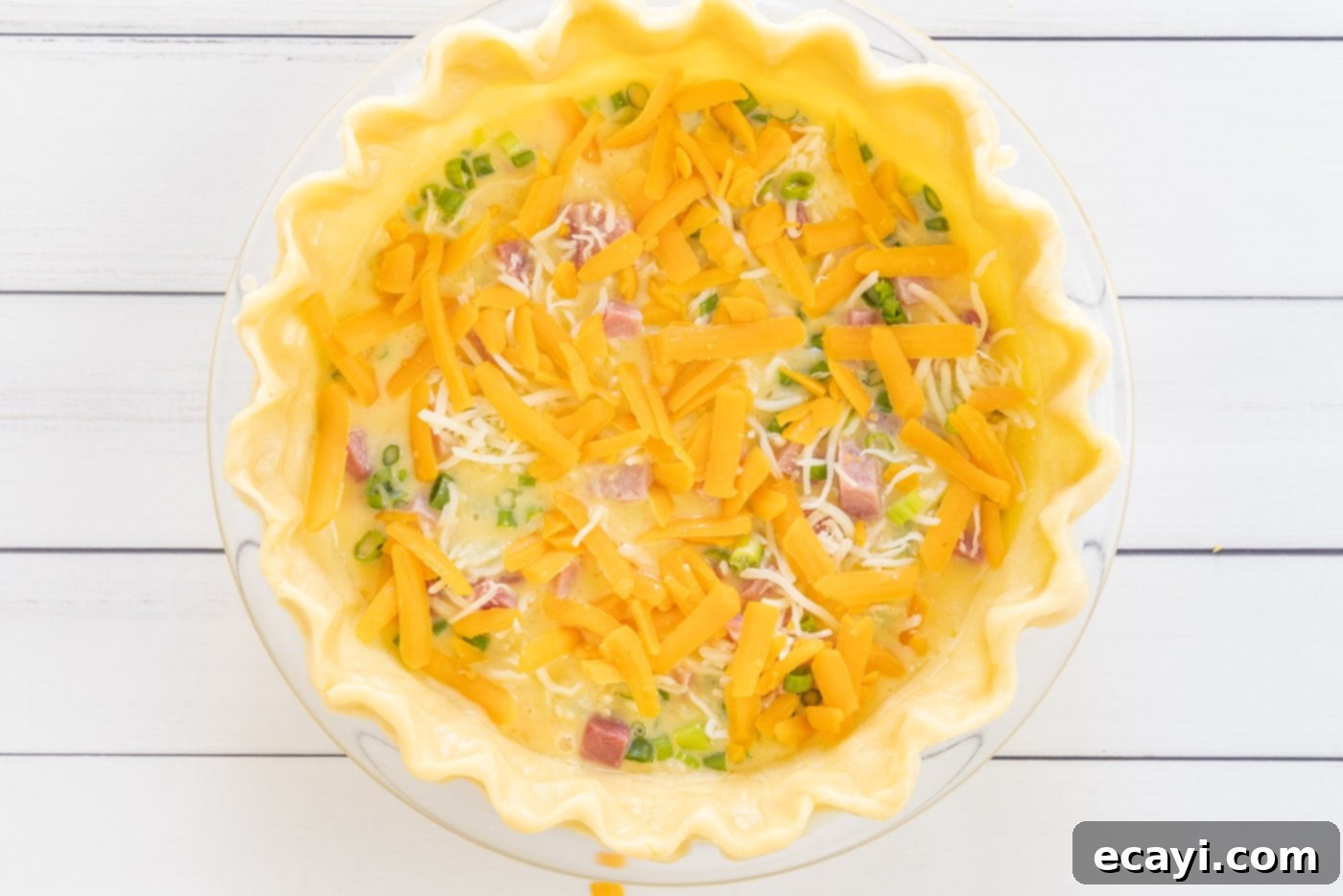 Savory Egg Custard Pie 11 Shredded cheddar and mozzarella cheese topping the layers of ham and green onions in the quiche.