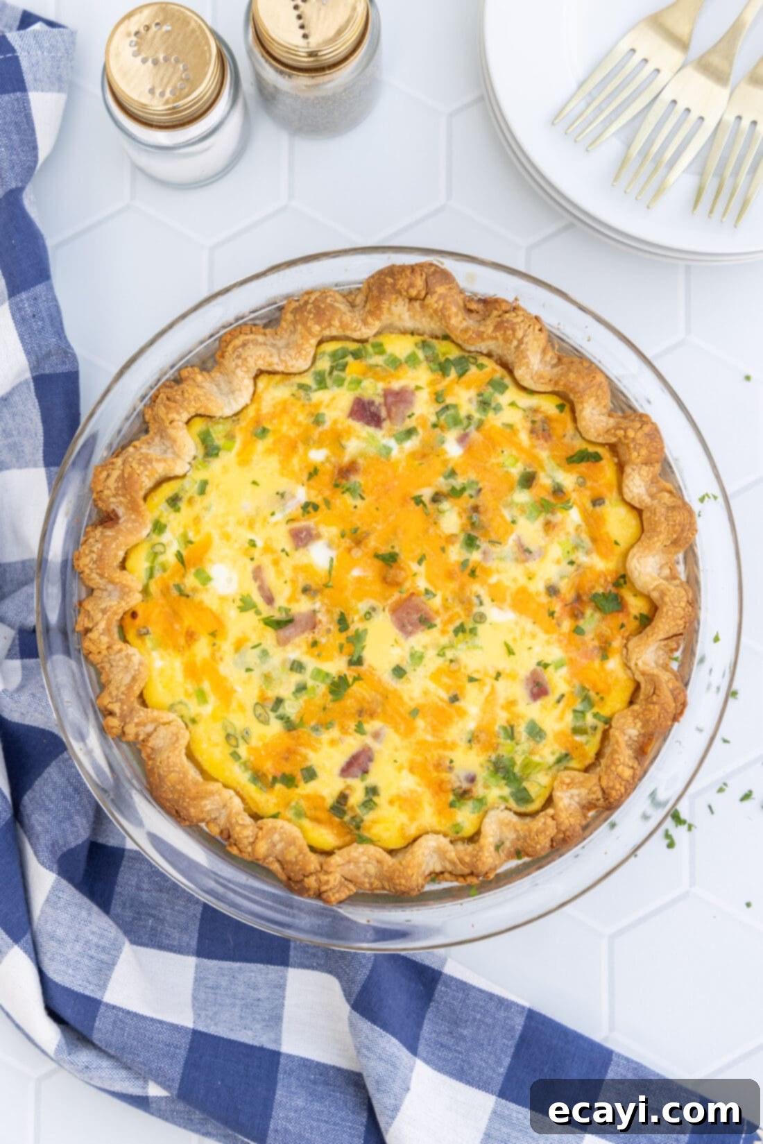 Savory Egg Custard Pie 3 A freshly baked Ham and Cheese Quiche, golden brown and puffed, ready to be sliced.