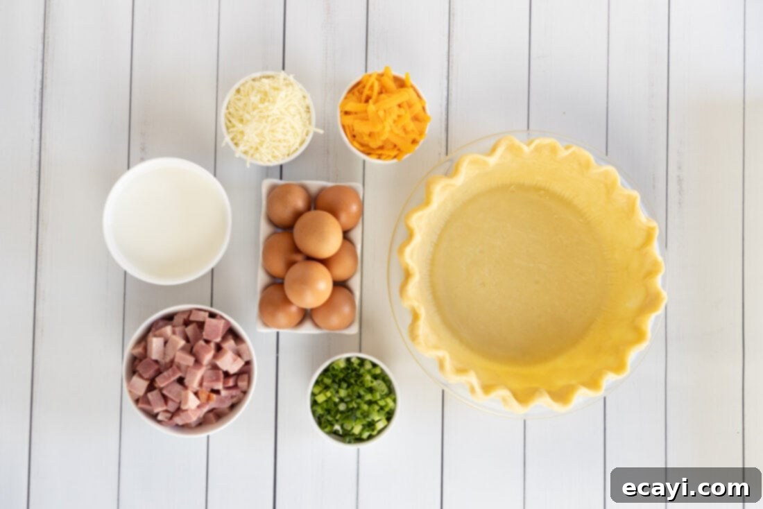 Savory Egg Custard Pie 4 A spread of fresh ingredients for Quiche: ham, green onions, eggs, milk, and two types of shredded cheese.