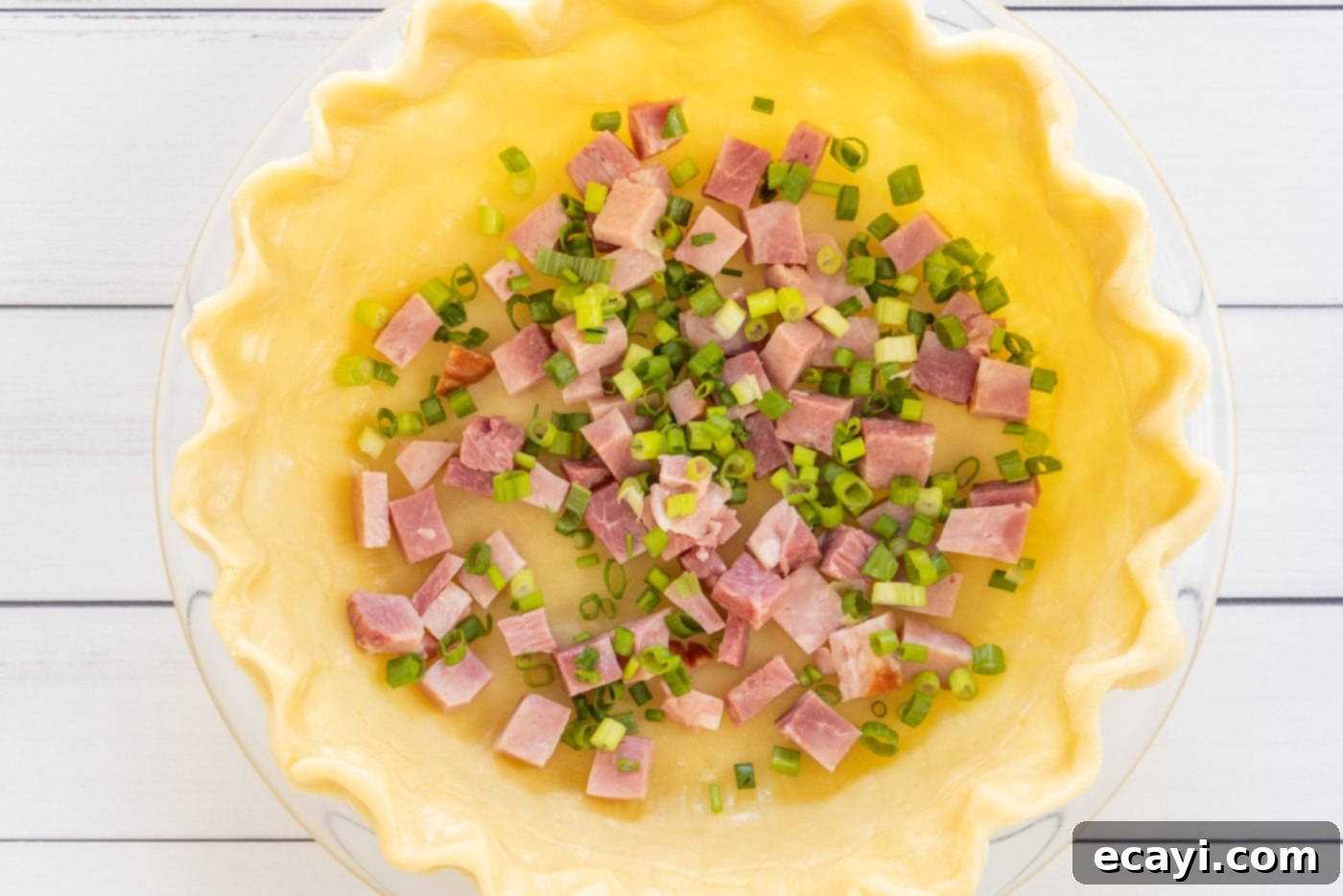 Savory Egg Custard Pie 6 Cubed ham and sliced green onions layered inside a deep-dish pie shell.