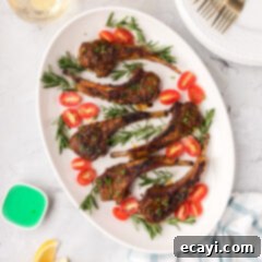 Tender Oven-Baked Lamb Chops 11 Baked Lamb Chops on an oval platter, garnished with fresh herbs.