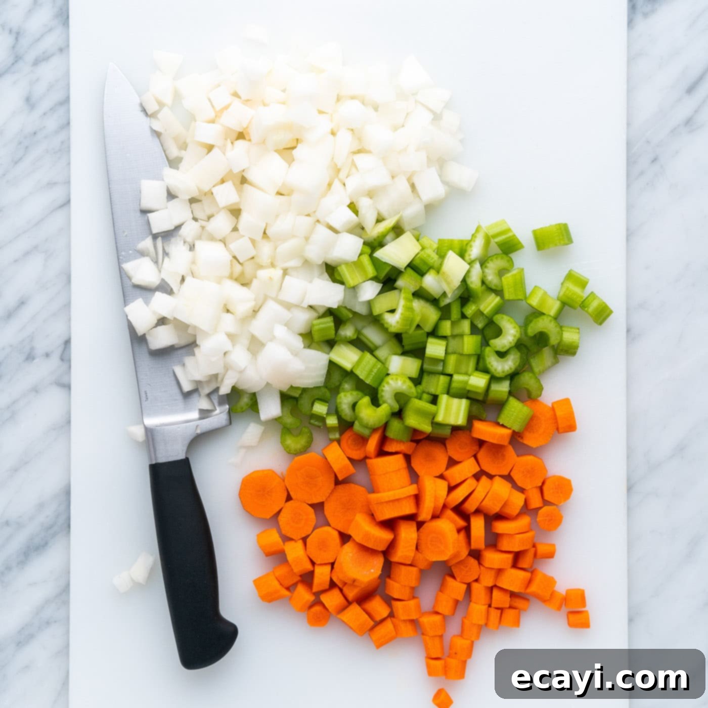 Soul-Warming Lentil Soup 5 Diced celery, onion, and carrots neatly arranged on a cutting board, ready for the soup pot.