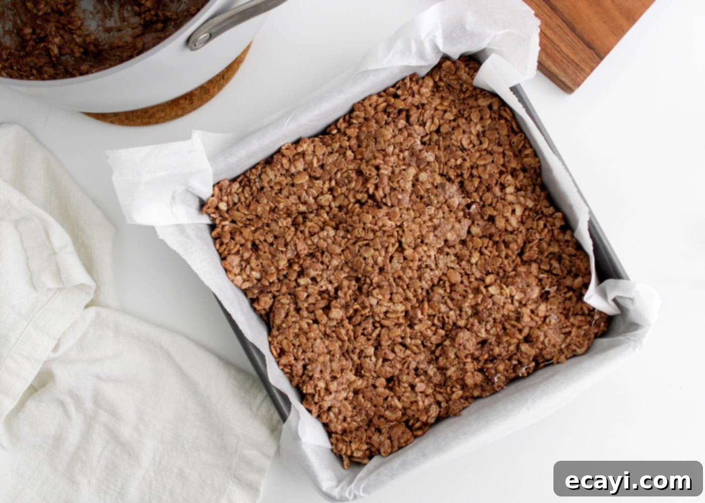 Cozy Cocoa Krispie Squares 10 hot chocolate rice krispie treats mixture pressed into a pan, ready for cooling
