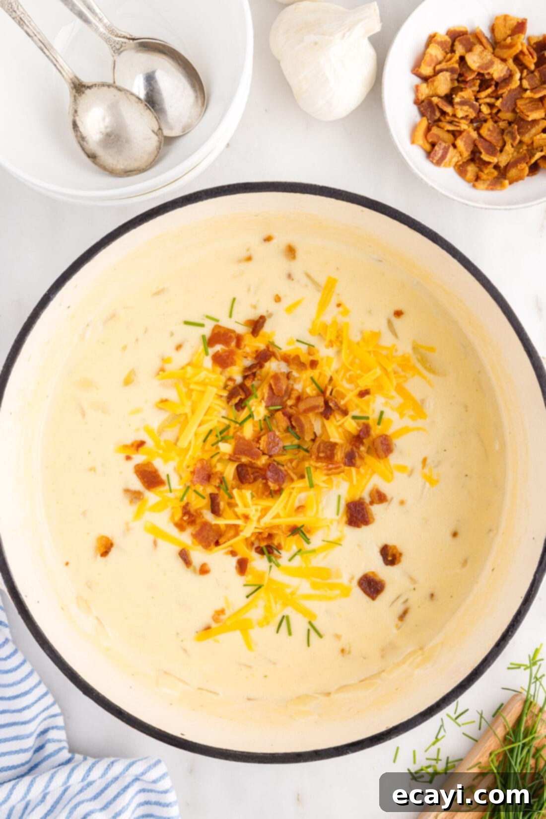 Loaded Baked Potato Soup 3 Large pot of homemade baked potato soup simmering on the stovetop, showcasing its rich, golden-brown color and creamy texture before serving