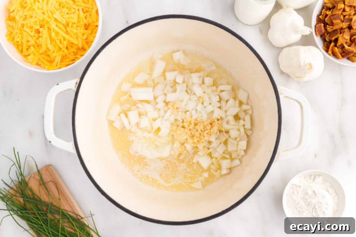 Loaded Baked Potato Soup 5 Sautéing finely chopped yellow onions and minced garlic in melted butter and bacon grease in a stockpot until softened and fragrant