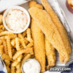 Crispy Fried Whiting 13 Fried Whiting Fish in a metal serving dish with fries