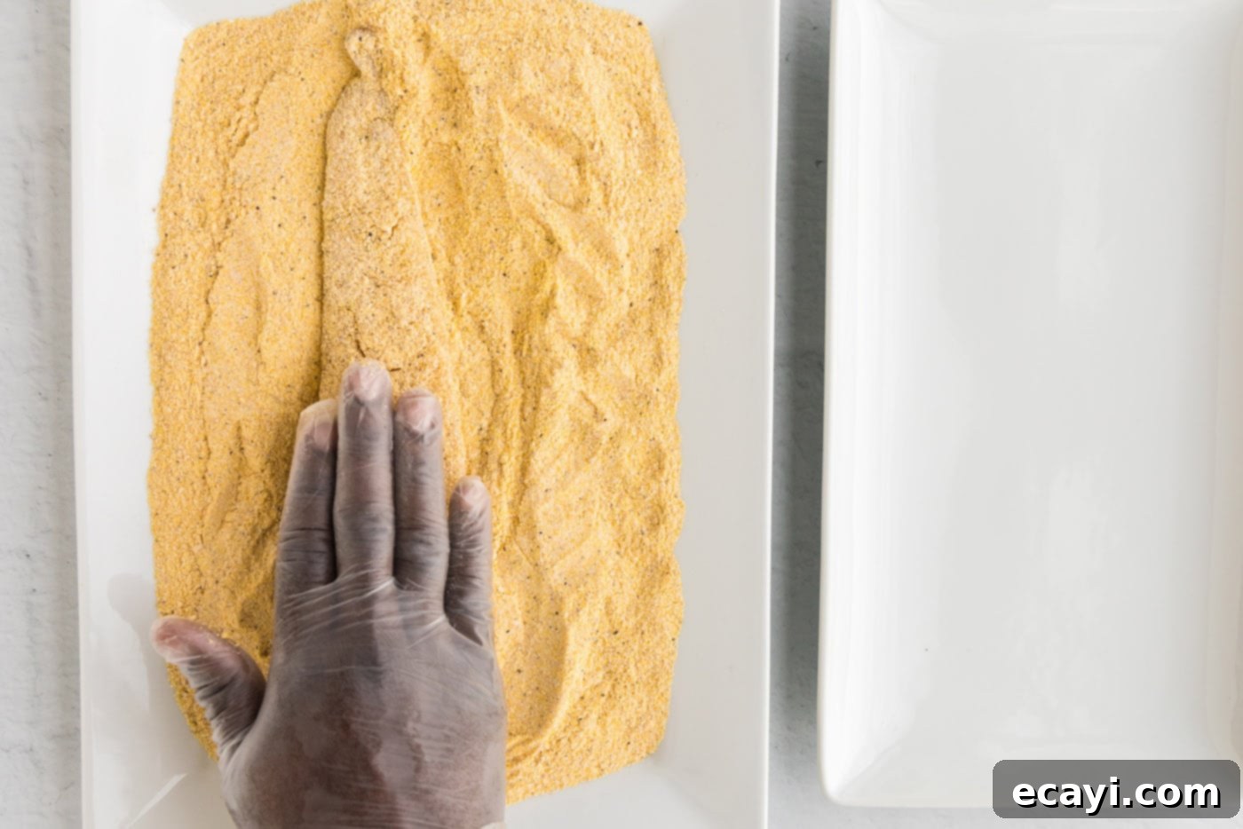 Crispy Fried Whiting 7 pressing fish into a cornmeal coating