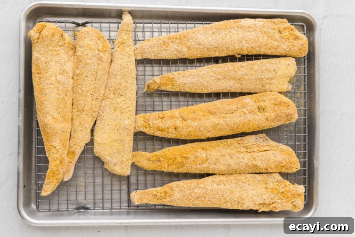 Crispy Fried Whiting 9 whiting fish in cormeal on a wire rack