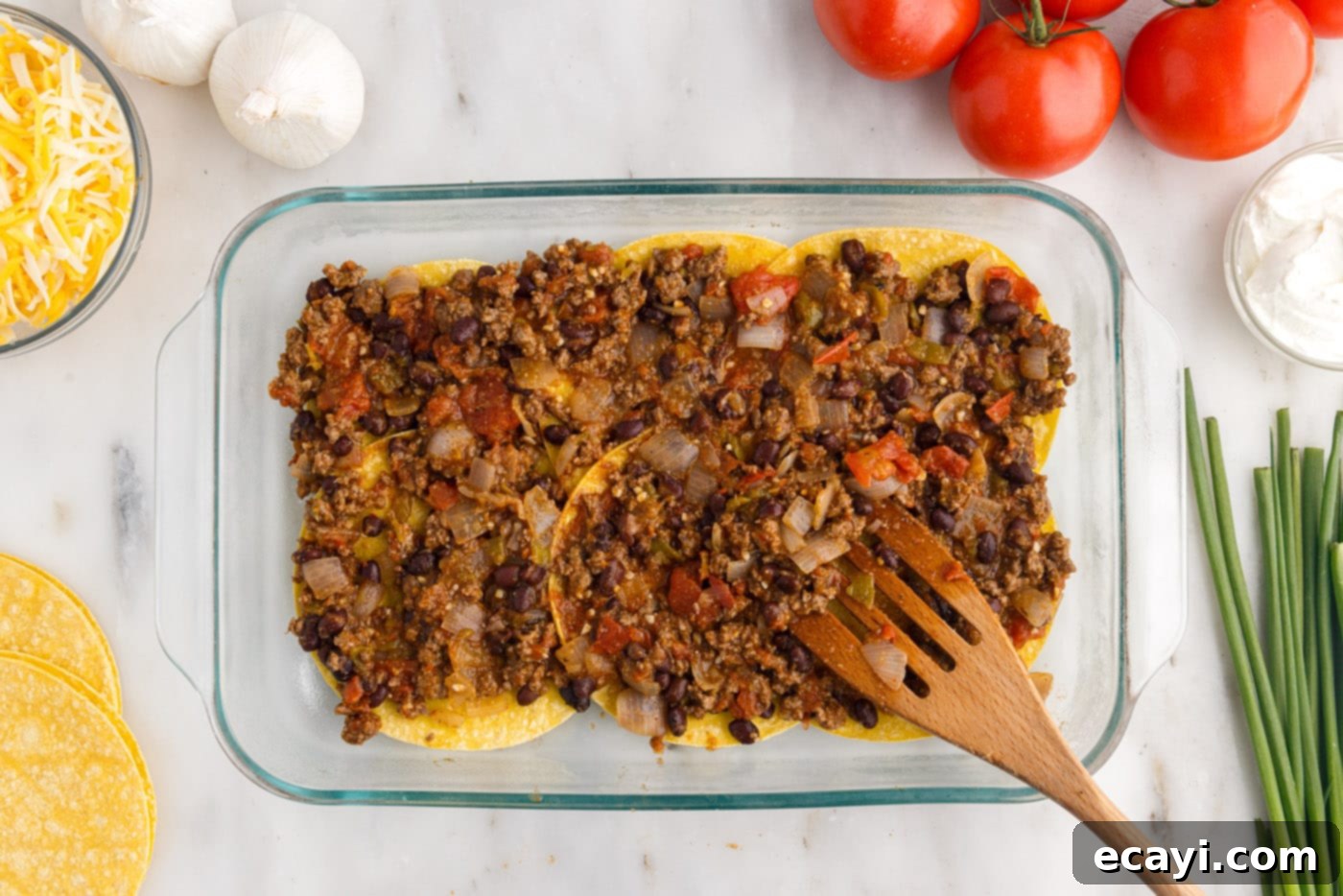 Tex-Mex Lasagna 11 Spreading meat mixture over corn tortillas in the baking dish