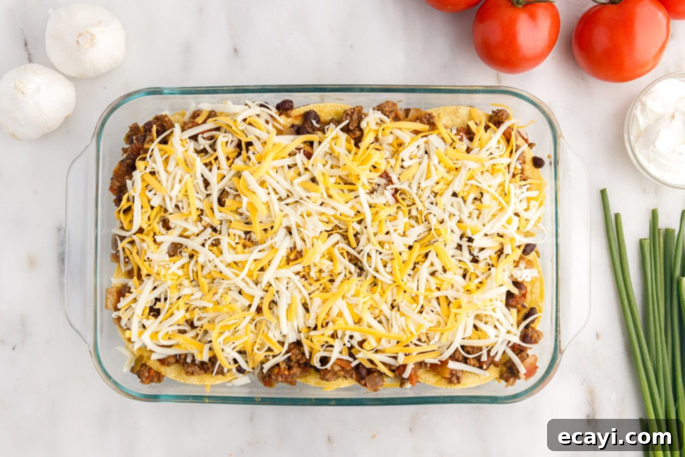 Tex-Mex Lasagna 12 Shredded cheese sprinkled on top of the corn tortillas and beef mixture