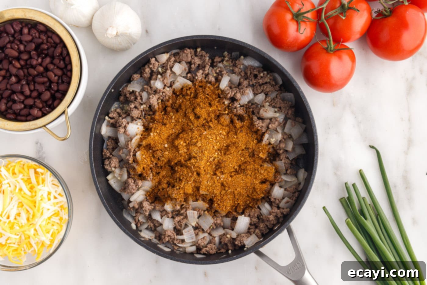 Tex-Mex Lasagna 7 taco seasoning added to the ground beef and onion mixture in a skillet