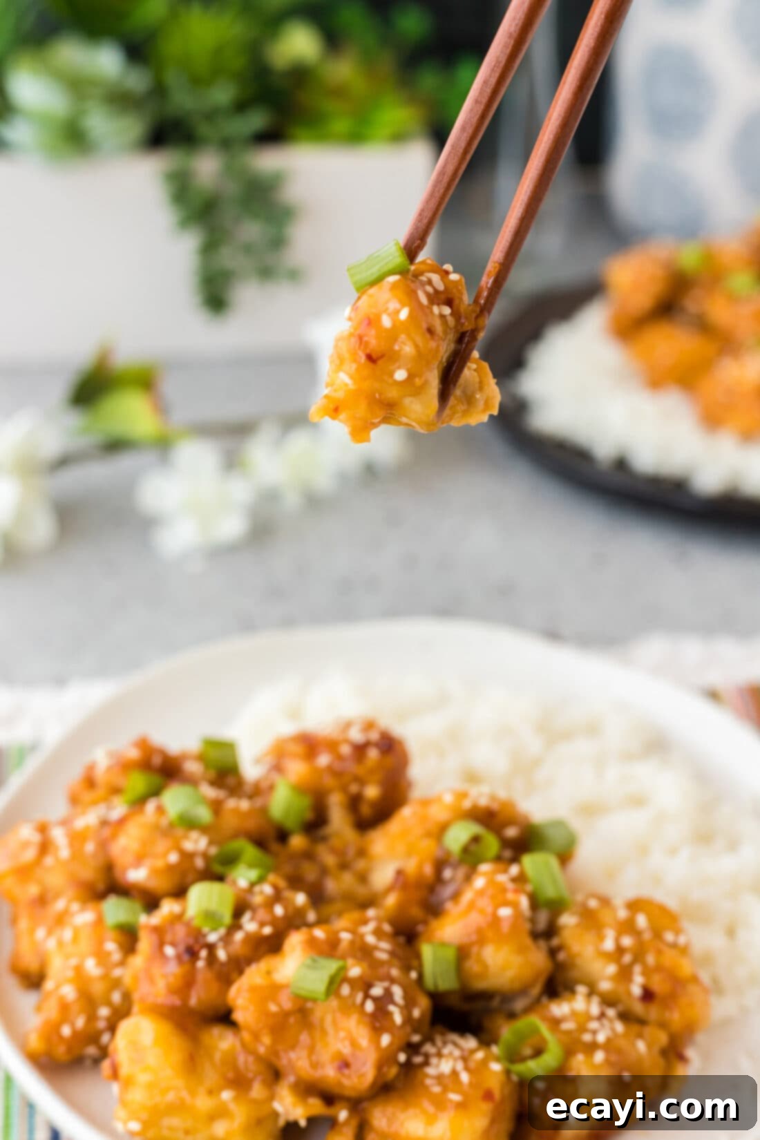 Tangy Orange Crunch Chicken 3 Piece of Orange Chicken in chopsticks