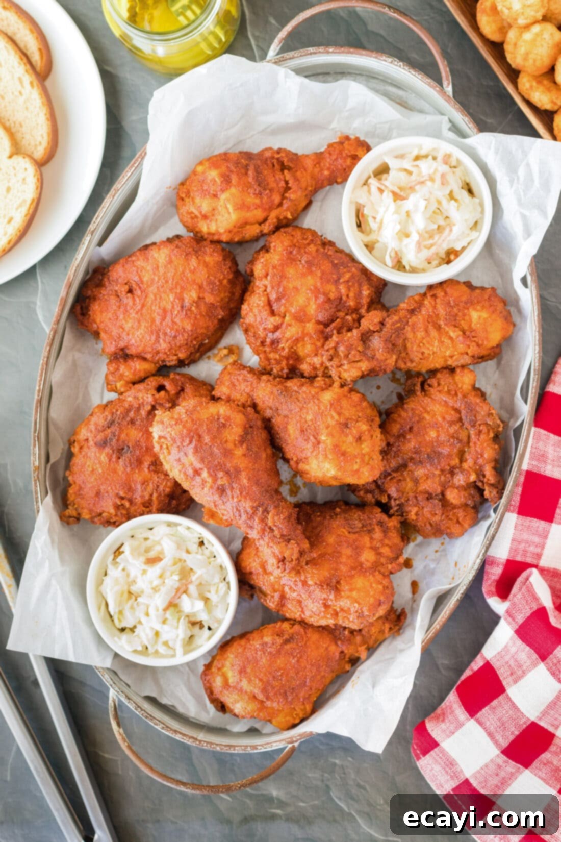 Nashville Hot Chicken 2 Platter of incredibly crispy and spicy Nashville Hot Chicken pieces, garnished with pickles.