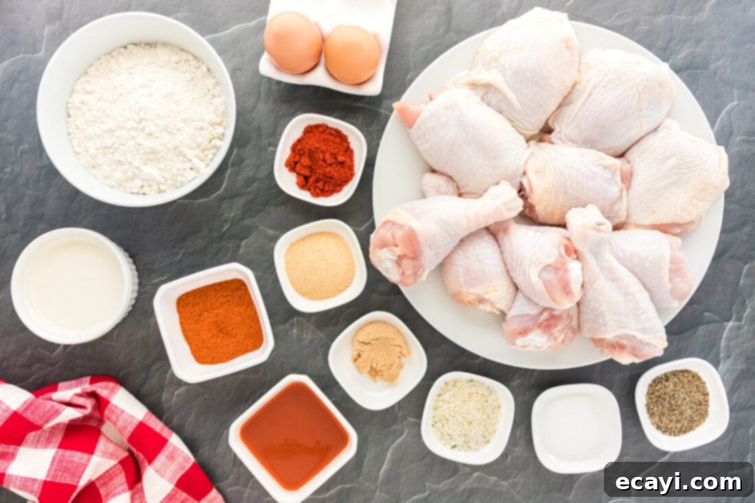 Nashville Hot Chicken 4 A selection of fresh ingredients including chicken, eggs, hot sauce, and spices laid out on a table, ready for making Nashville Hot Chicken.