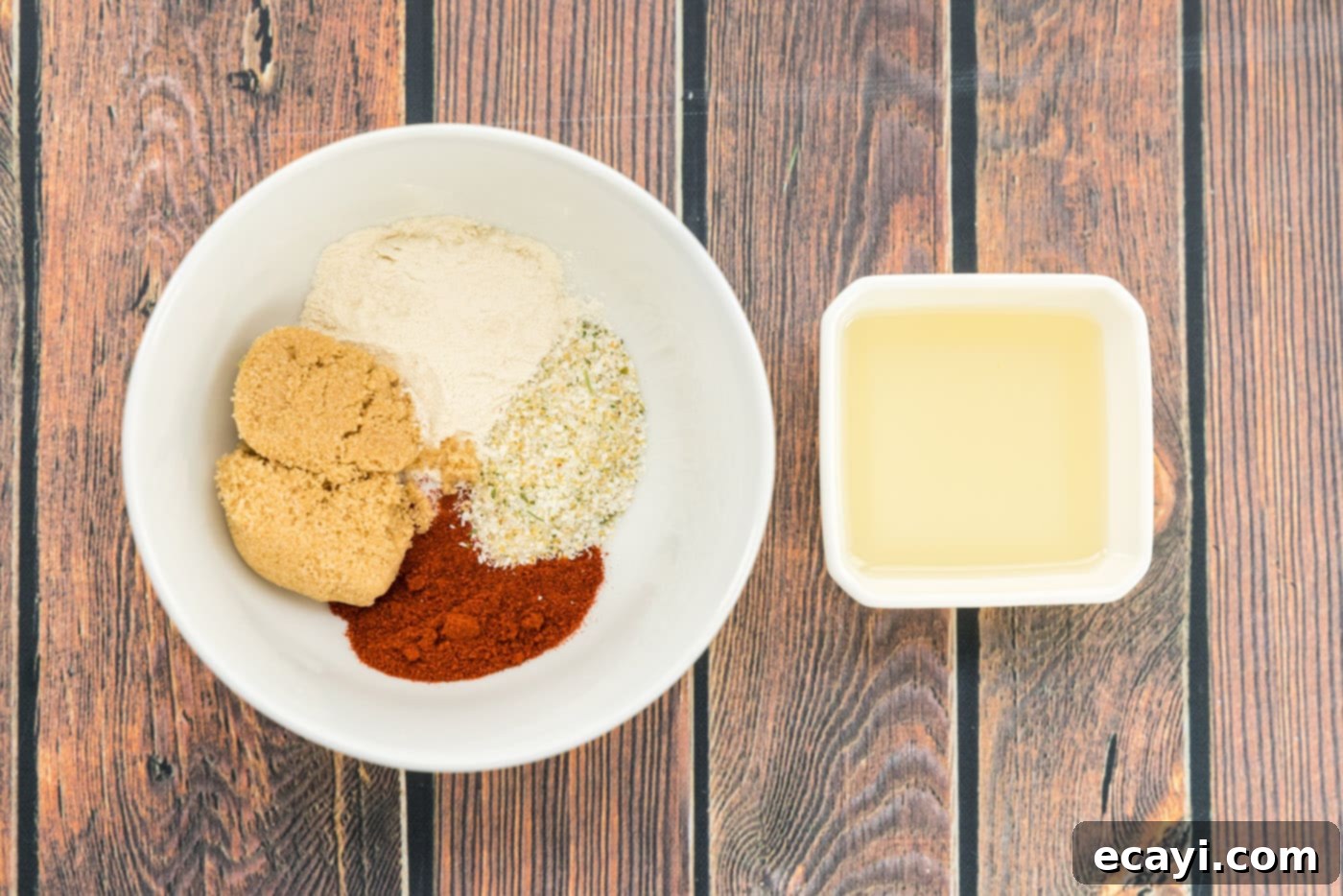 Tender Instant Pot Pork Chops 5 seasonings in a bowl next to olive oil